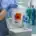 Nurse-placing-tamper-evident-specimen-bag-with-biohazard-symbol-into-cooler