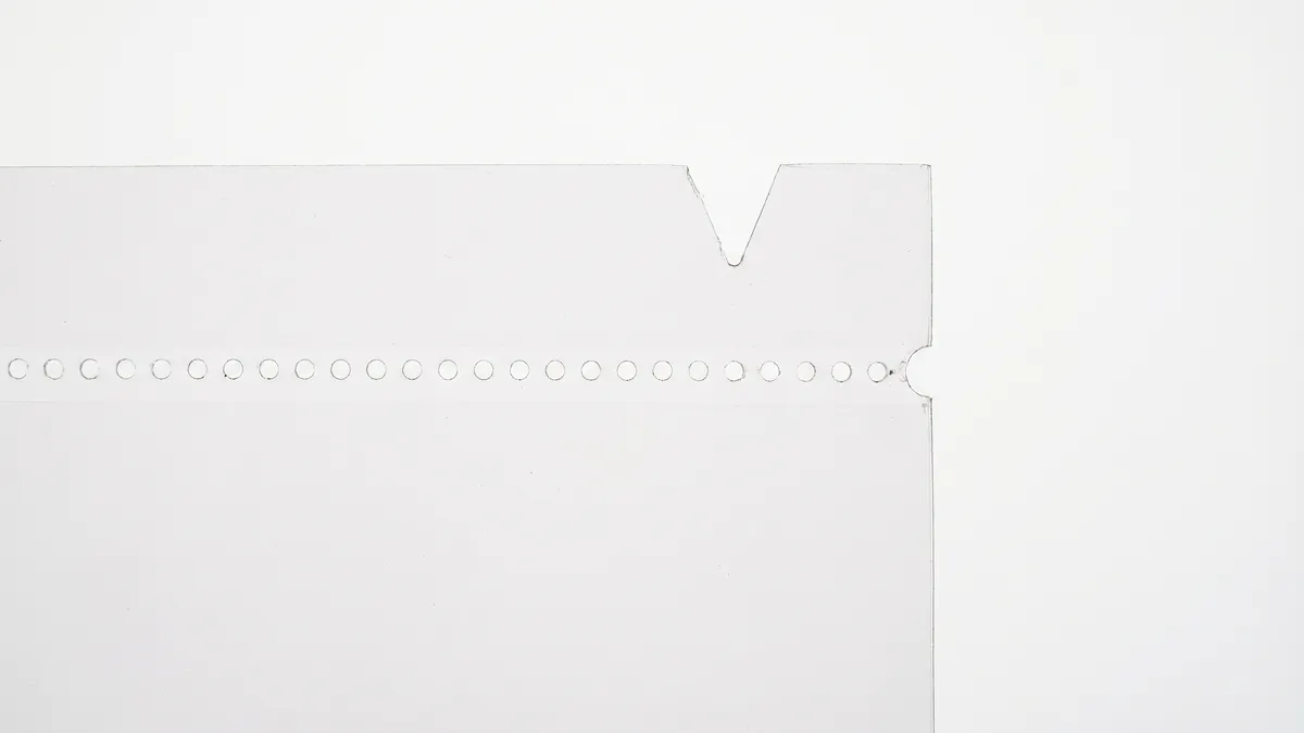 Close-up of micro-perforation and laser perforation techniques on packaging film showing precise hole patterns