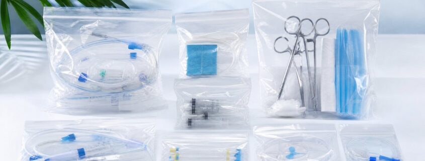 Transparent unprinted medical bags containing surgical instruments, syringes and diagnostic kits on a clean white surface — PPWR-aligned medical packaging solution